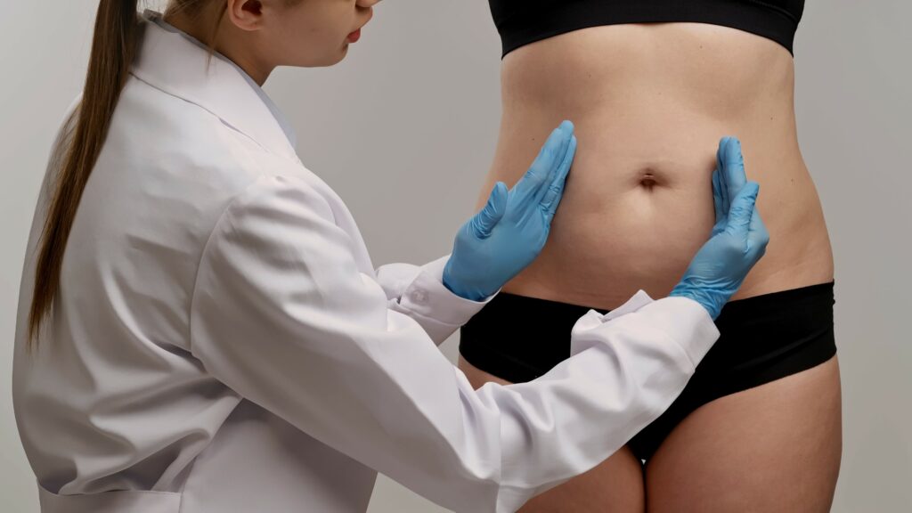 Healthcare Professional Examining Patient's Abdominal Area