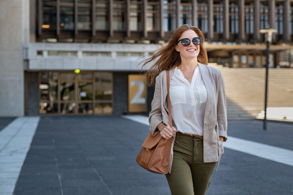 Happy mature woman walking confidently