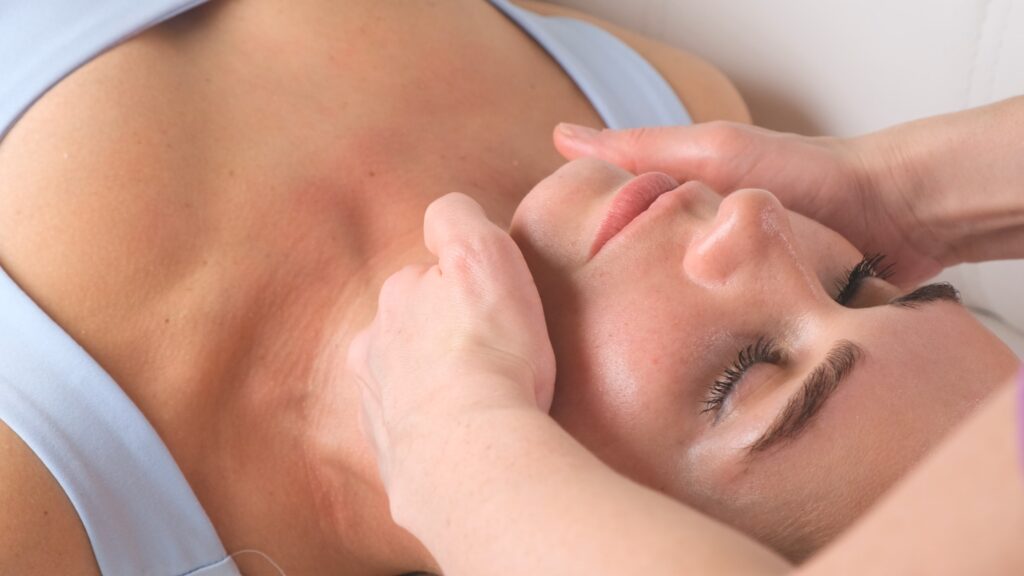 Chin massage of woman young woman during face massage at beauty salon