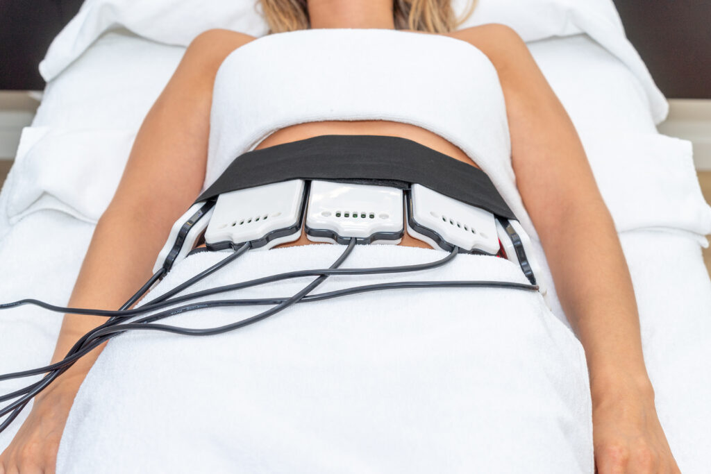 Woman receiving slimming lipo laser therapy in spa